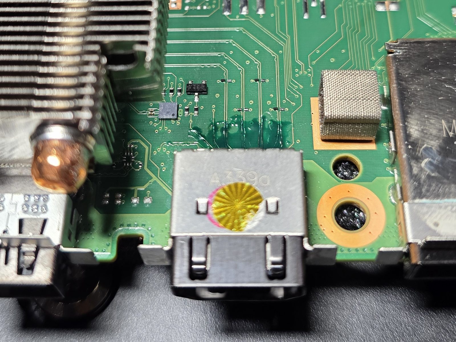 Rebuilt traces behind the HDMI connector on an Xbox Series X board following an HDMI port repair